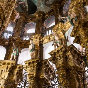 Columnas salomónicas doradas con ángeles y vidrios en el cierre barroco de la Capilla Mayor de la Catedral de Santiago.